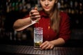 Female bartender adding a fresh mint for a cane sugar with lime Royalty Free Stock Photo