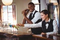 Female bartender garnishing cocktail with olive Royalty Free Stock Photo