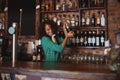 Female bartender mixing a cocktail drink in cocktail shaker Royalty Free Stock Photo