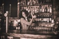 Female bartender mixing a cocktail drink in cocktail shaker Royalty Free Stock Photo