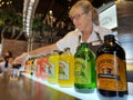 Female bartender pouring into cups Bundaberg Brewed drinks during tasting experience