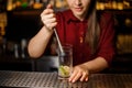 Female bartender pressing down a cane sugar with lime Royalty Free Stock Photo