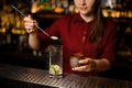 Female bartender putting a cane sugar into a glass Royalty Free Stock Photo