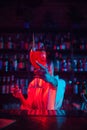 Female bartender serving delicious Aperol Spritz cocktail in modern neon colored bar. Traditional cocktails Royalty Free Stock Photo