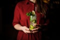 Female bartender serving a fresh delicious cocktail Caipirinha