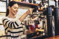 Female bartender tapping beer in bar Royalty Free Stock Photo
