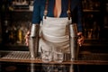 Female bartender holding two steel cocktail shakers on the bar c Royalty Free Stock Photo