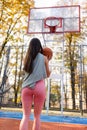 Female basketball player getting ready to make a ball throw to the basket. Royalty Free Stock Photo