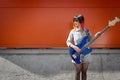 Female bass guitar player posing with blue bass Royalty Free Stock Photo