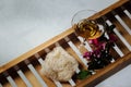 Female bathroom - romantic bath with natural pumice, glass of white wine, pink flowers and candle on shelf for a bathtub Royalty Free Stock Photo