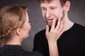 Female beautician apply cream on male mouth.