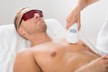 Beautician Giving Laser Epilation On Man`s Chest Royalty Free Stock Photo