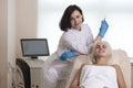 Female Beautician Near Patient During Augmentation and Correction Procedure in Cosmetology Salon During Injection Of Collagen To Royalty Free Stock Photo