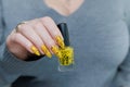 Female beautiful hand with long nails and a yellow nail polish Royalty Free Stock Photo