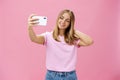 Female beauty blogger taking selfie post new look online. Portrait of charming tanned young woman in t-shirt touching