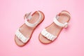 Female beige sandals on a pink background close-up top view. Royalty Free Stock Photo