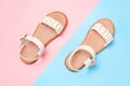 Female beige sandals on pink and blue background close-up top view. Royalty Free Stock Photo