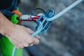 Female belayer with the rope and carabines. Royalty Free Stock Photo