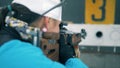 Female biathlete is shooting and one target is being closed