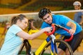 female bicycle technician mending cyclist bike