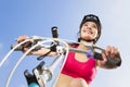 Female biker starting to ride with blue sky background