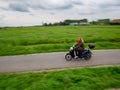 A female biker in Zaanse Schans. The Zaanse Schans is a typically Dutch small village in Amsterdam, Netherlands.