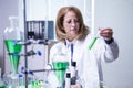 Female biologist wearing a white coat for academic research