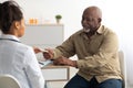 Female black doctor showing pills to male patient Royalty Free Stock Photo