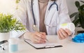 Female black medicine doctor hand hold jar of pills and write prescription to patient at worktable. Panacea and life save,