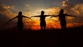 Female black silhouettes doing yoga in sunset background and meditating.