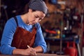 Female Blacksmith Wearing Headscarf Working On Design In Forge Royalty Free Stock Photo