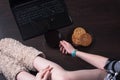 A female blogger. coffee in front of laptop, sitting on the floor, body parts