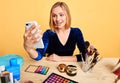 Female blogger making beauty reviews from her smartphone, online translation