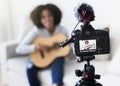 Female blogger recording music related broadcast at home