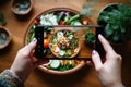 Female blogger takes a photo of a bowl of Asian food on her smartphone. Generative AI