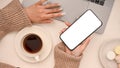 Female blogger working in her minimal workspace, using laptop and smartphone Royalty Free Stock Photo