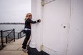 Female blond woman hugs the Portland Breakwater Lighthouse, aka Bug Lighthouse