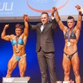 Female bodybuilders celebrate their championship victory on stage