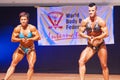 Female bodybuilders flex their muscles to show their physique