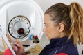 female boiler technician observing defect Royalty Free Stock Photo