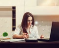 Female bookkeeper in glasses working at the table