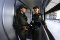 Female border guards in uniform standing in front of a window of a corridor of a passenger train