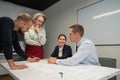 The female boss evaluates the work of subordinates. Designers engineers at a meeting.