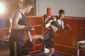 Female boxer practicing kickboxing with trainer her trainer Royalty Free Stock Photo