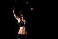 Female boxer training in the dark ring. Silhouette. Boxing concept. Fighter woman fist close up. Sexy girl with perfect body in Royalty Free Stock Photo