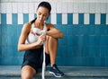 Female boxer is wrapping hands with boxing wraps