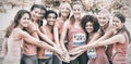 Female breast cancer marathon runners stacking hands Royalty Free Stock Photo