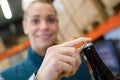 female brewer opening beer bottle Royalty Free Stock Photo