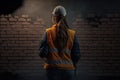 female bricklayer in front of brick wall, equality concept generate by AI Royalty Free Stock Photo