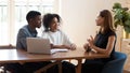 Female broker makes offer to young African couple during meeting